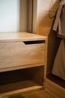 wooden bureau on top of a rug, side table, night table photo