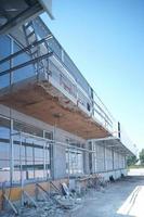 two people walking, in an industrial building repair, all white, steel column, steel beams repair photo