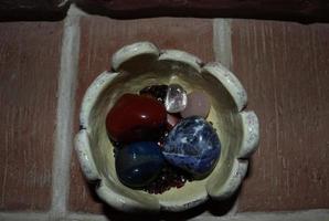 Bowl in which crystals and semi-precious stones are various photo