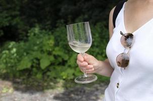 Wine tasting event - woman holding a glass of white wine photo