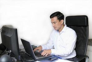 Man working from home with a laptop at a desk photo