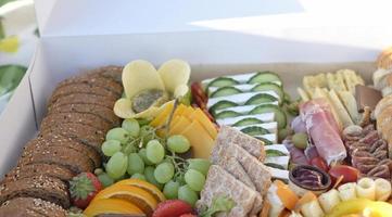 Delicious and inviting picnic box filled with a variety of finger food photo