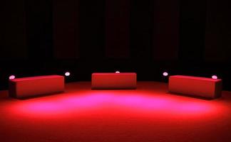 Three seats and red lighting on stage photo