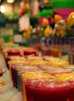 Market booth with colorful fresh juice and smoothies photo