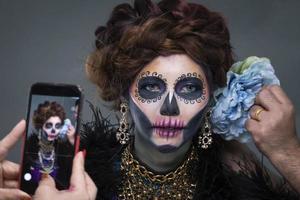 Closeup portrait of female model with a sugar skull makeup photo