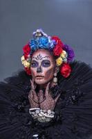 Closeup portrait of female model with a sugar skull makeup photo