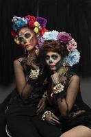 Female models with a sugar skull makeup. photo