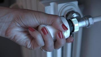 Female hand turns radiator valve video