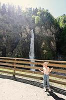 Girl against waterfall in Liechtensteinklamm or Liechtenstein Gorge, Austria. photo