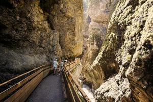 Mother hikking with four kids in Liechtensteinklamm or Liechtenstein Gorge, Austria. photo