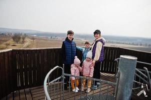 Mother with kids on wooden observation tower. photo