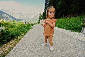 Baby girl at path to caves at Mount Krippenstein in Hallstatt, Upper Austria, Europe. photo