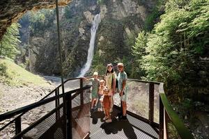 Mother with children against waterfall in Liechtensteinklamm or Liechtenstein Gorge, Austria. photo