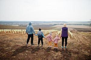 Back of family stand against vineyard in early spring. photo