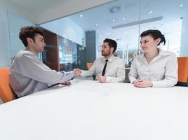 young couple signing contract documents on partners back photo