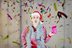 business woman wearing a red hat and blowing party whistle photo