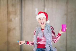 young business woman wearing a red hat and blowing party whistle photo