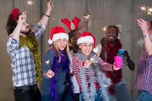 multiethnic group of casual business people dancing with sparklers photo