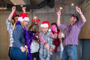 multiethnic group of casual business people dancing with sparklers photo