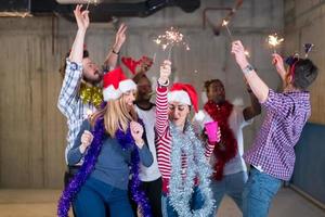 multiethnic group of casual business people dancing with sparklers photo