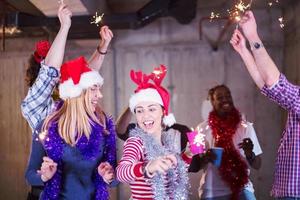 multiethnic group of casual business people dancing with sparklers photo