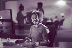 man working on computer in dark office photo