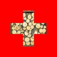 Outline map of Switzerland flag with the image of the national flag. Firewood inside the map. Collage illustration. Energy crisis. photo