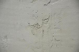 The texture of the wall, covered with gray foam polystyrene plates, which are smeared with a reinforcing mixture. Stage of wall insulation photo