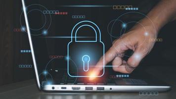 Cyber security online concept. The businessman touches his finger on the laptop with lock icon. Connect to a network, internet, personal data, and protection. password and intelligence technology. photo