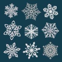 gráficos vectoriales de copos de nieve sobre un fondo blanco cortados de papel, 6 rayos. vector