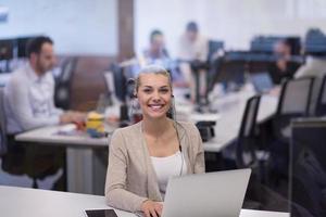 businesswoman using a laptop in startup office photo