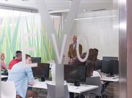 senior teacher and students group in computer lab classroom photo