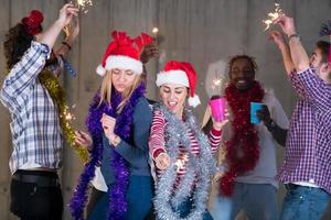 multiethnic group of casual business people dancing with sparklers photo