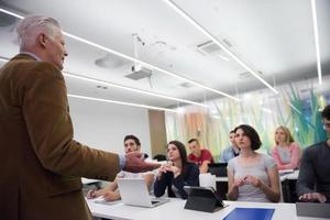 teacher with a group of students in classroom photo