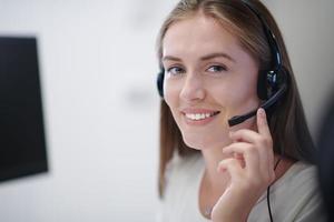 Business woman with headsets at work photo