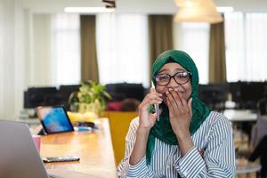 african muslim business woman using mobile phone photo