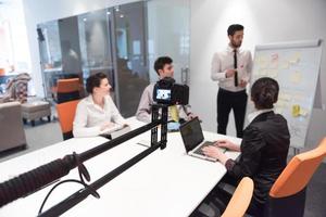 business people group brainstorming and taking notes to flip board photo