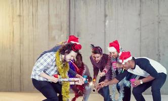 multiethnic group of casual business people lighting a sparkler photo