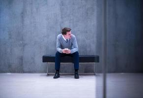 businessman using smart phone while sitting on the bench photo