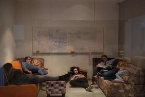 software developers sleeping on sofa in creative startup office photo