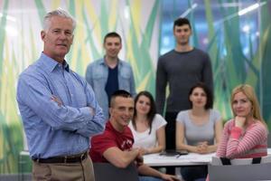 portrait of  teacher with students group in background photo