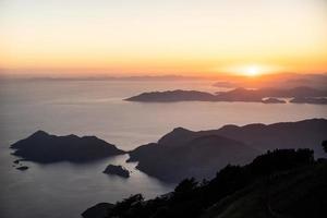 beautiful landscape from a drone on the sea, mountains at sunset photo