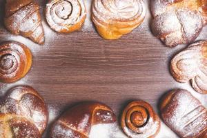 a beautiful composition of various sweet buns laid out around the perimeter photo