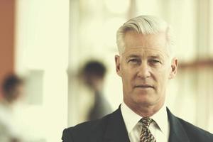 portrait of handsome senior business man at modern office photo