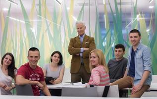 portrait of  teacher with students group in background photo