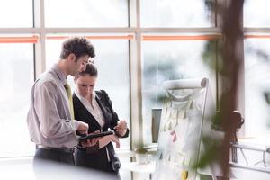 young couple working on flip board at office photo