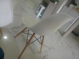 modern white chair on marble floor photo