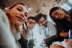 a crazy portrait of a group of entrepreneurs sitting in a modern office. photo