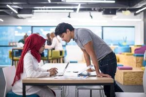 black muslim business woman having a meeting with her indian male colleague photo