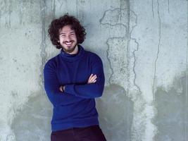 portrait of casual businessman in front of a concrete wall photo